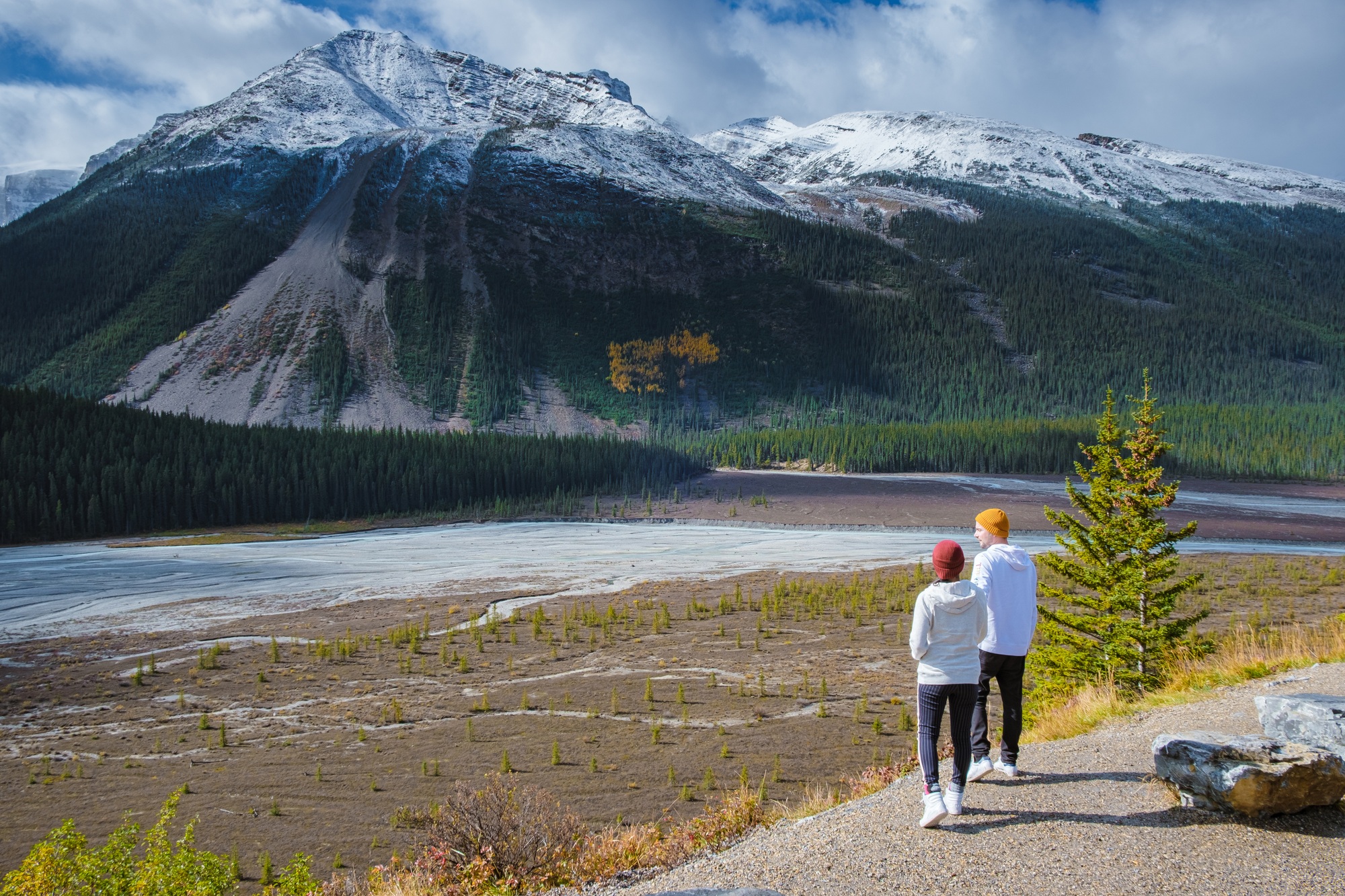 the Icefields Parkway with autumn trees and snowy foggy mountains in Jasper Canada Alberta
